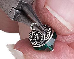 Pliers forming a loop above bead cap